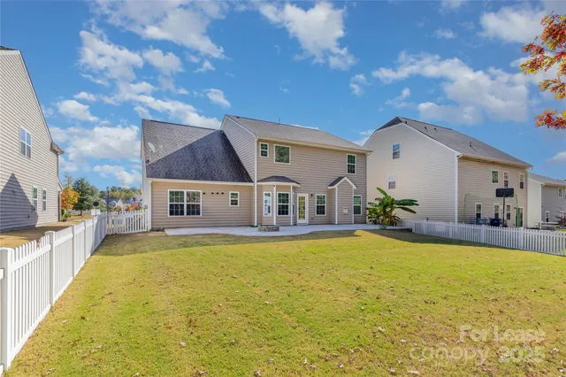 a view of a house with swimming pool and a yard