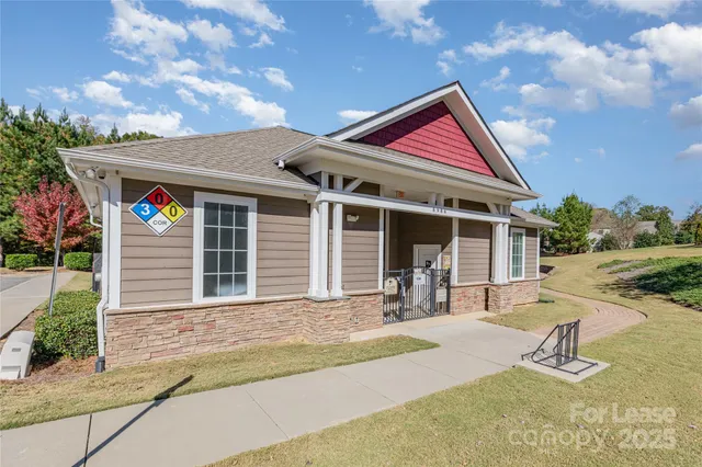a front view of a house with garden and seating area