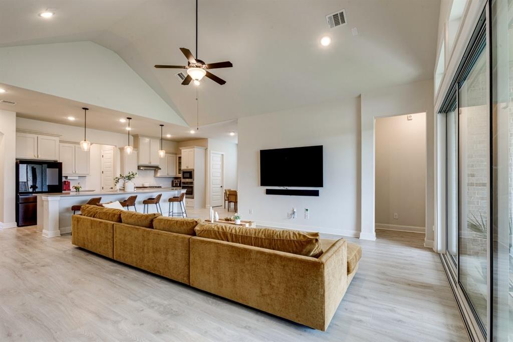 9613 Boulder Pt Road Oak Point, TX 75068 - Photo 13 of 28 Open-concept living space featuring wood-finish flooring, a vaulted ceiling with a ceiling fan, and recessed lighting