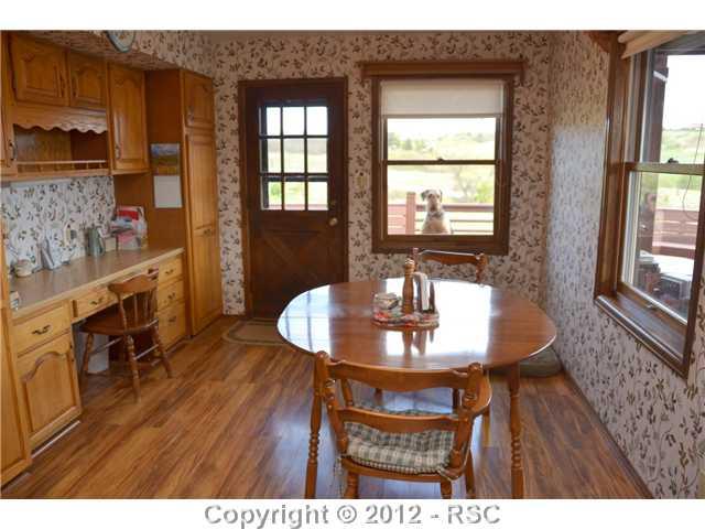 890 Walsen Road Colorado Springs, CO 80921 - Photo 7 of 16 Breakfast Nook with Wood Flooring, Desk & Walkout to Deck