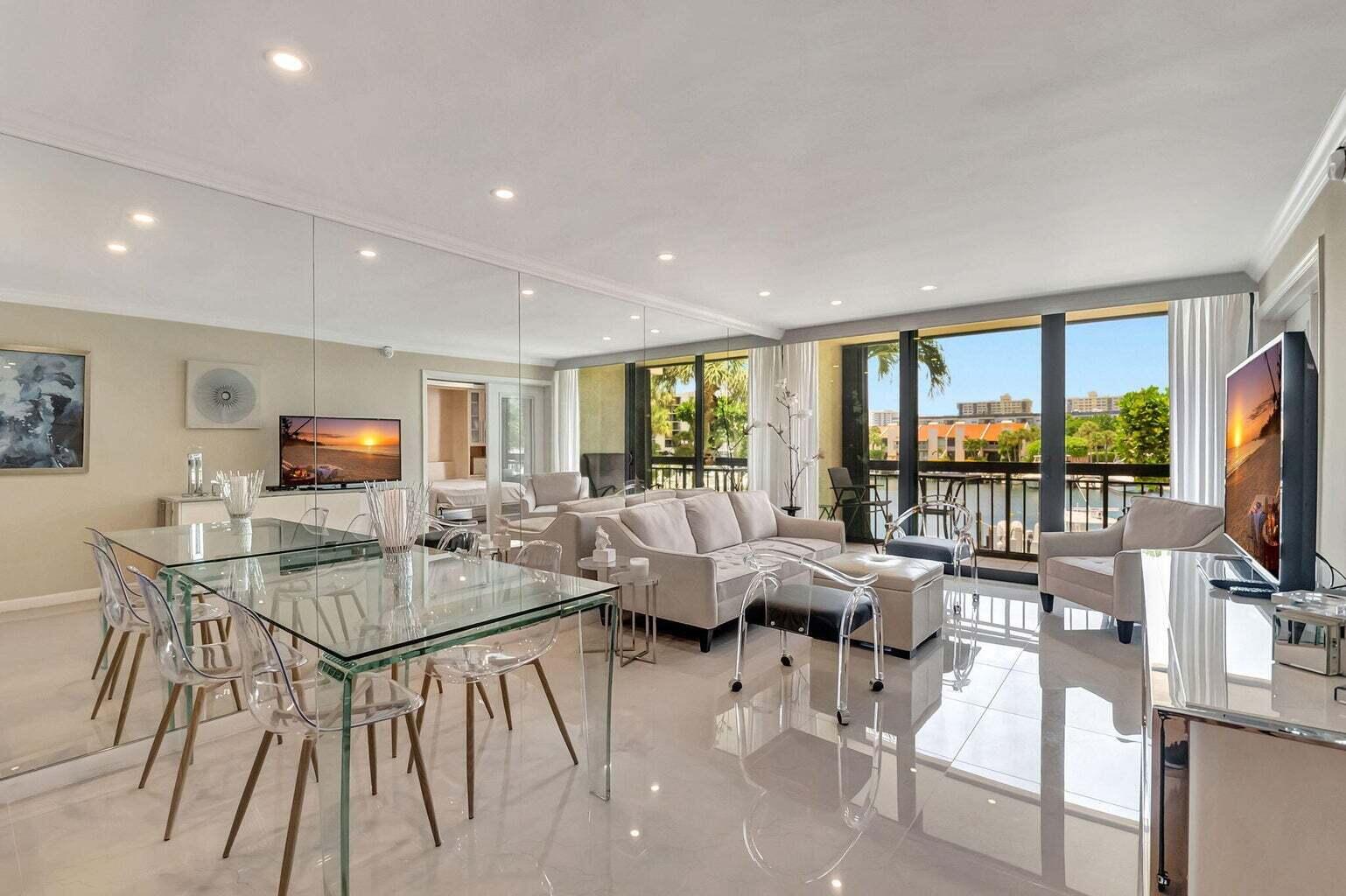 2707 North Ocean Boulevard, Unit D205 Boca Raton, FL 33431 - Photo 7 of 51 a living room with furniture a flat screen tv and a large window
