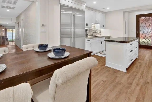 a kitchen with stainless steel appliances granite countertop a sink and cabinets