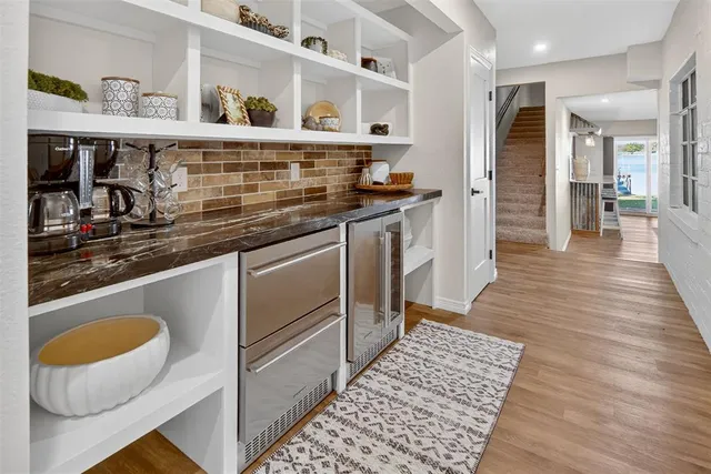 a kitchen with stainless steel appliances granite countertop a sink and wooden cabinets