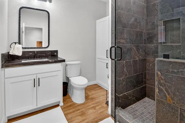 a bathroom with a toilet sink and mirror