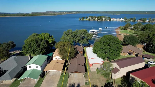 an aerial view of a house with a garden and lake view