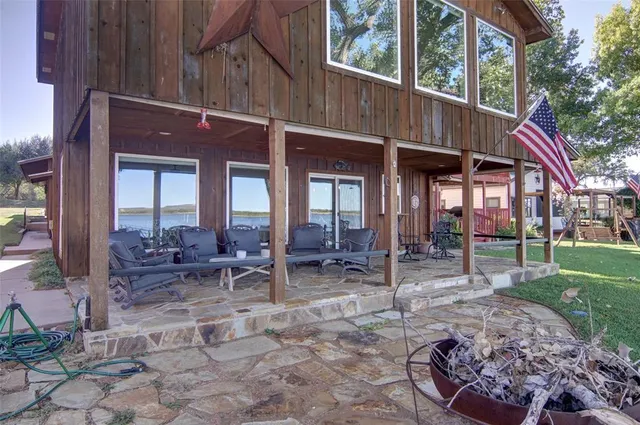 a view of a house with backyard porch and sitting area