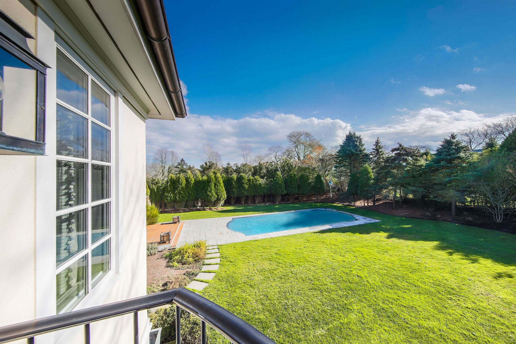 8 Pondview Lane East Hampton, NY 11937 - Photo 6 of 23 a view of a swimming pool with an outdoor seating and a garden