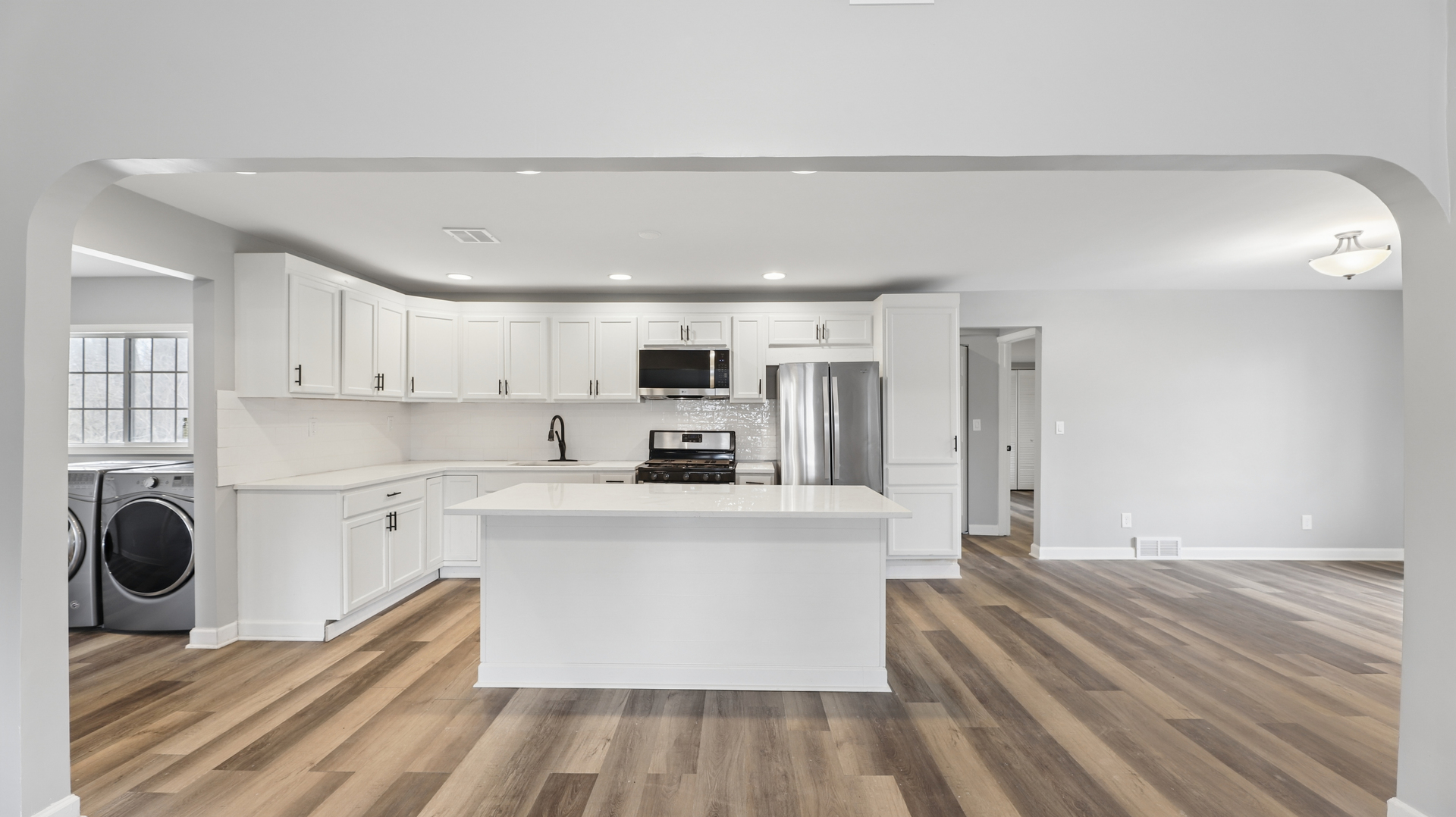 1624 Chicago Street Dixon, IL 61021 - Photo 12 of 29 a large white kitchen with wooden floor and stainless steel appliances