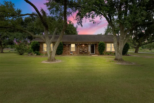 a front view of house with yard and green space