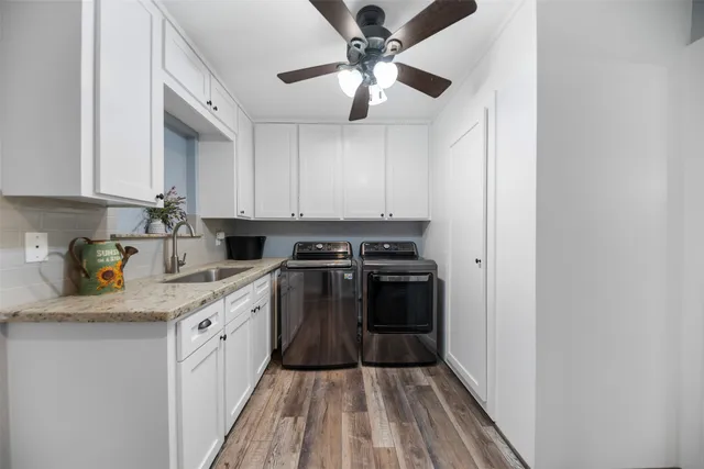 a kitchen with stainless steel appliances granite countertop a sink and a stove