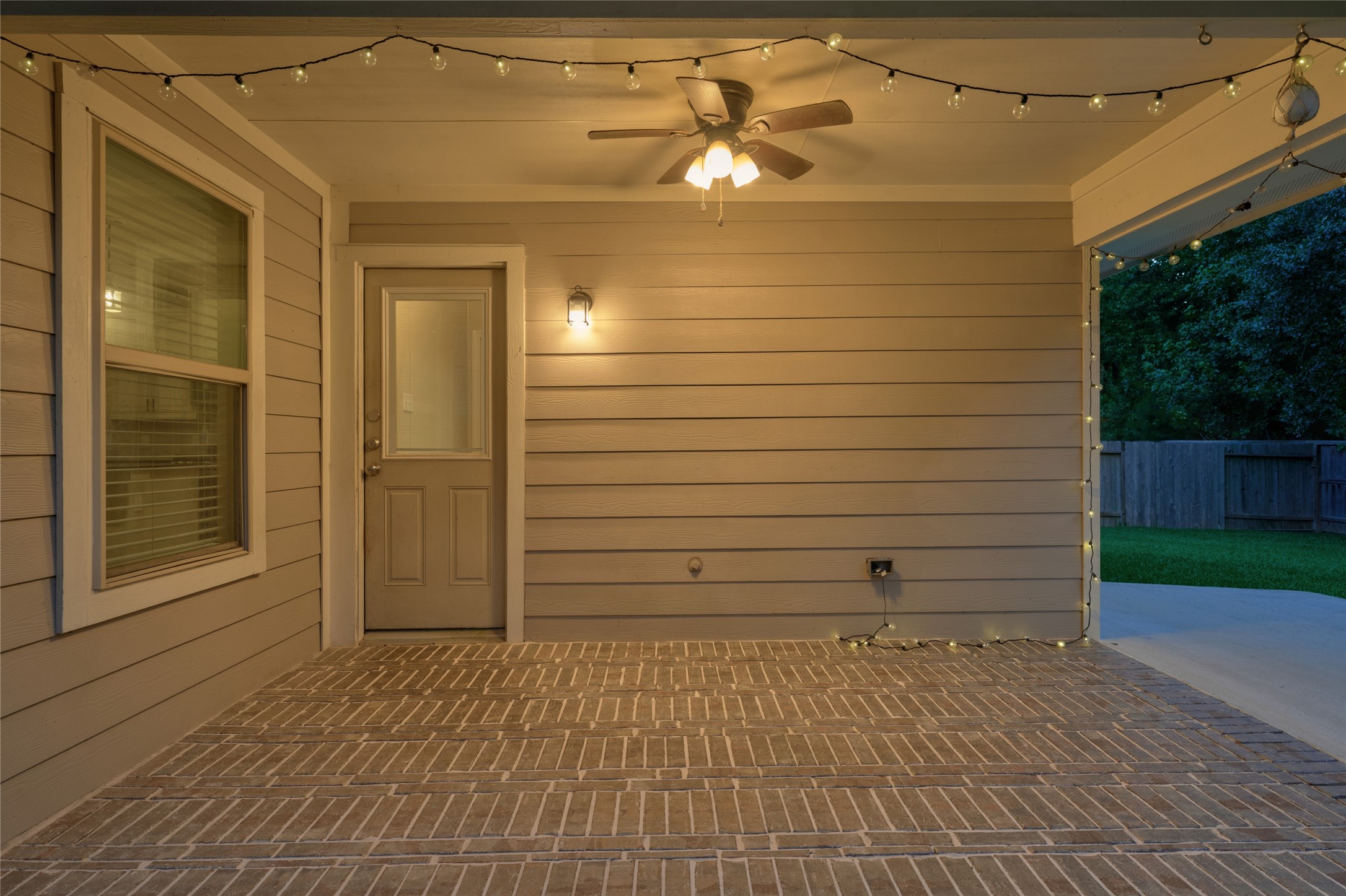 116 Fox Trail Road Montgomery, TX 77316 - Photo 39 of 50 Well-lit covered patio with string lights and a ceiling fan.