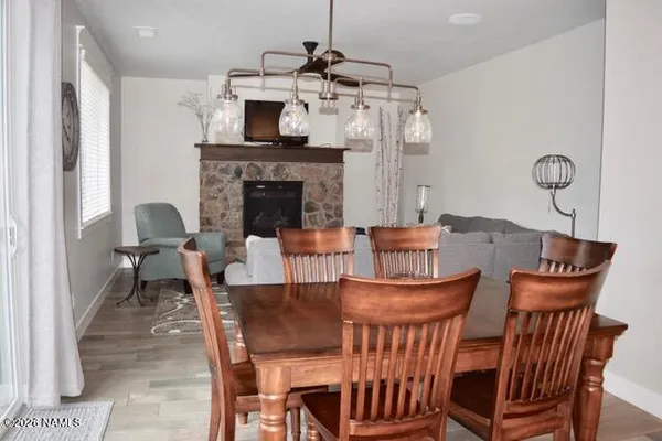 a dining room with furniture a chandelier and wooden floor