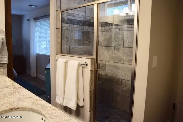 a bathroom with a glass shower door