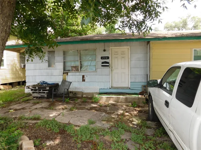 a backyard of a house with table and chairs