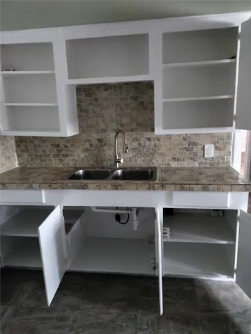 a kitchen with a sink and cabinets