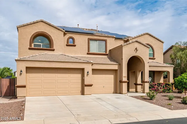 a view of a white house with large windows
