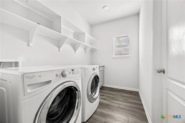 a view of a hallway with washer and dryer