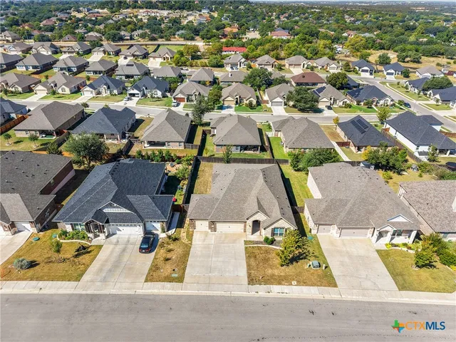 an aerial view of residential houses with outdoor space