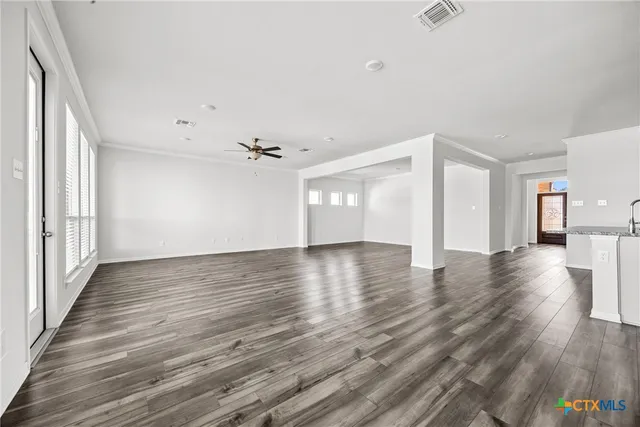 wooden floor in an empty room with a window