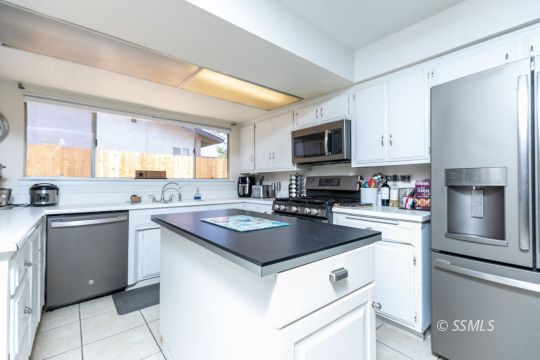 1021 West Iowa Avenue Ridgecrest, CA 93555 - Photo 17 of 40 a kitchen with cabinets appliances a sink and a counter top space