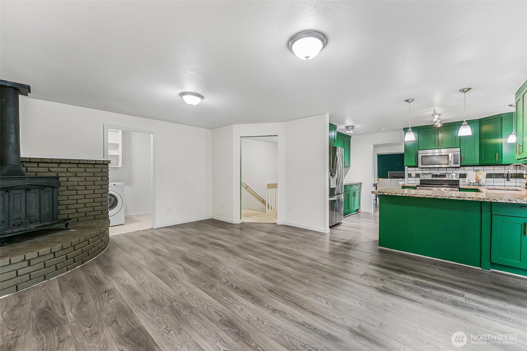 11404 Karshner Road East Edgewood, WA 98372 - Photo 14 of 40 a view of a kitchen with a sink and a fireplace