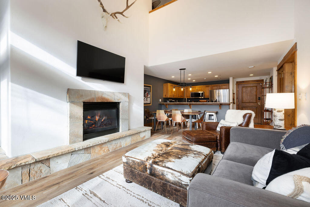 30 Cresta Road, Unit 308 Edwards, CO 81632 - Photo 1 of 9 a living room with furniture a fireplace and a flat screen tv