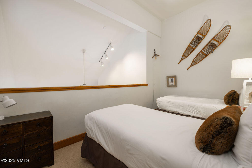 30 Cresta Road, Unit 308 Edwards, CO 81632 - Photo 7 of 9 a bedroom with a bed and a painting on the wall