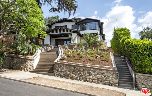 a front view of a house with lots of trees