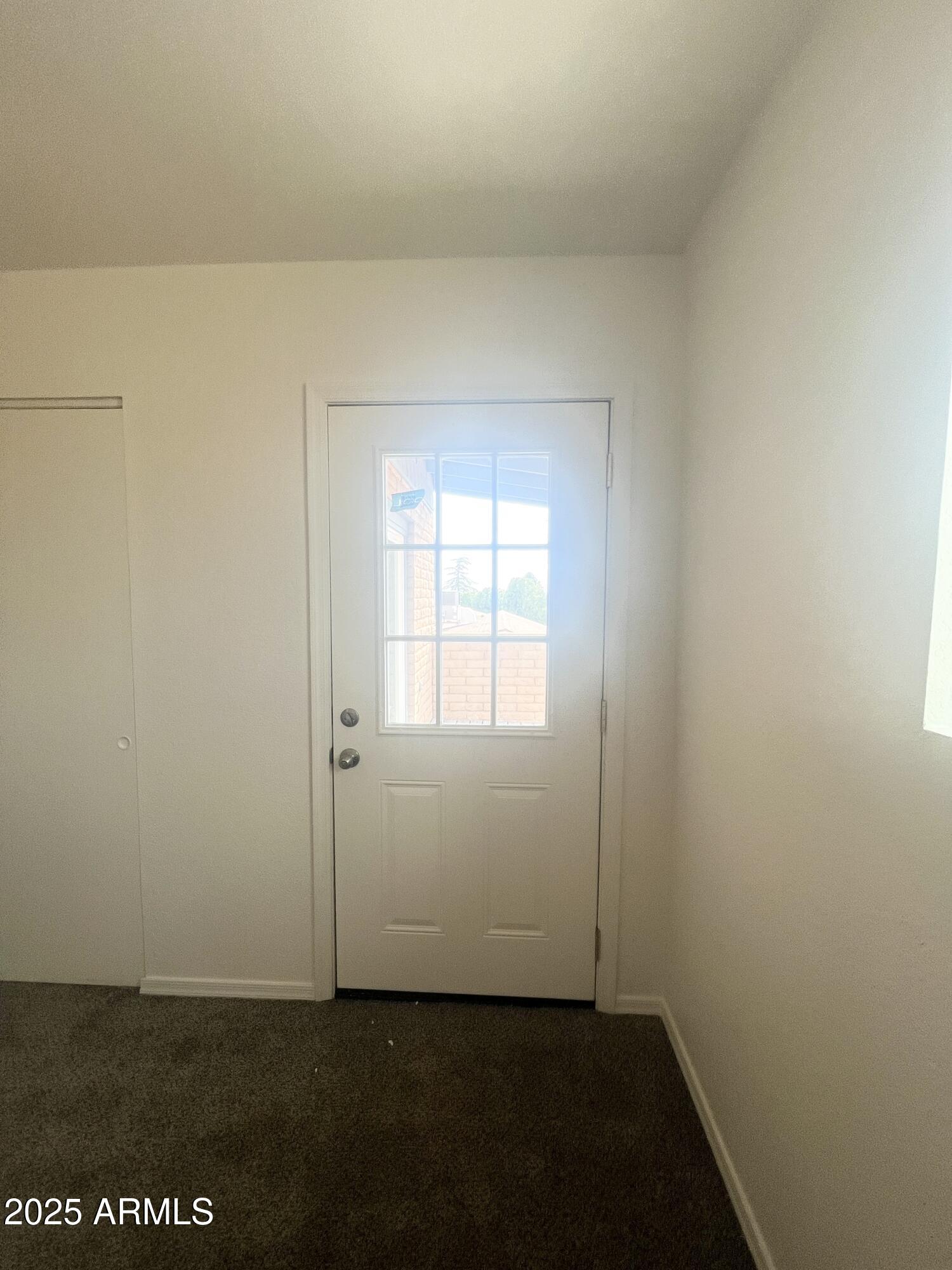 2075 11th Street Douglas, AZ 85607 - Photo 16 of 34 an empty room with wooden floor closet and windows
