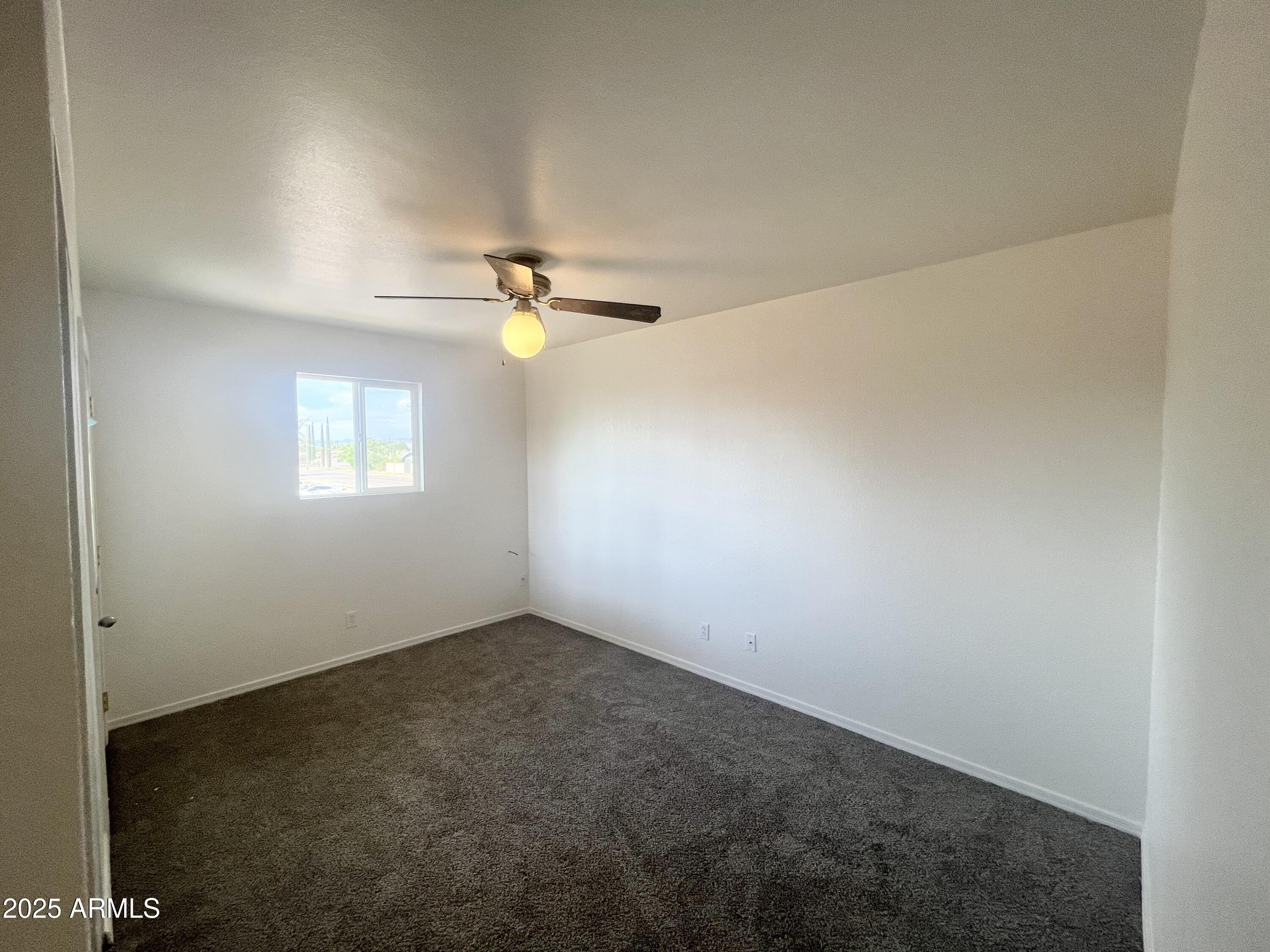 2075 11th Street Douglas, AZ 85607 - Photo 17 of 34 an empty room with windows and fan