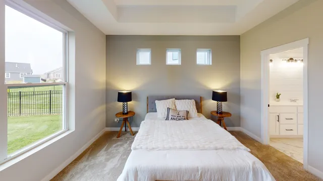 a bed room with a bed and a large window