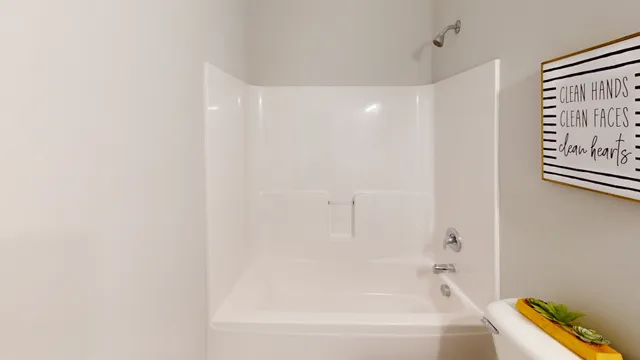 a bathroom with a bathtub and shower