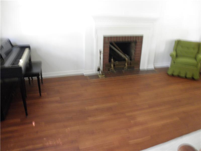 157 Orchard Spring Road Pittsburgh, PA 15220 - Photo 2 of 14 Living Room. EXPOSED HARDWOOD FLOOR AND LOG BURNING FIREPLACE HELP TO MAKE FOR A COZY LIVING ROOM.