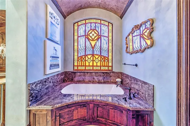 a living room with stainless steel appliances furniture and a flat screen tv