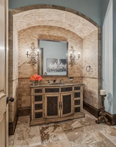 a living room with furniture a bookshelf and a window