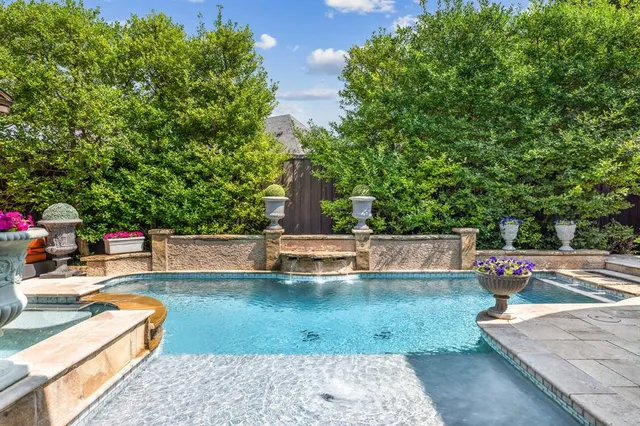 a kitchen with a sink and large windows