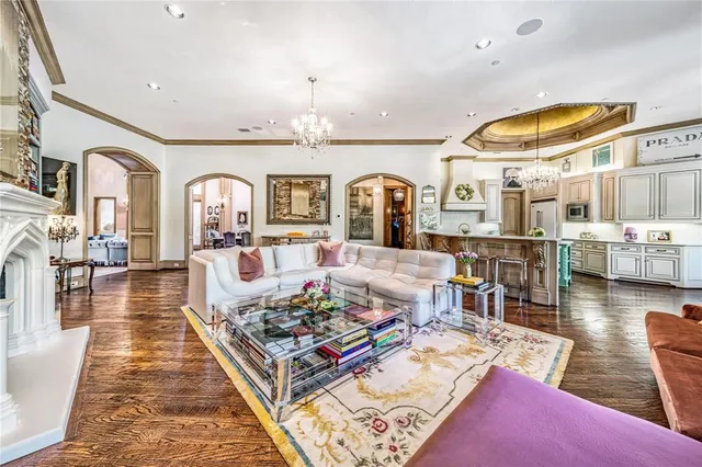 a living room with lots of furniture and view of kitchen