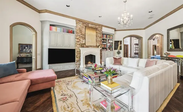a living room with furniture fireplace and dining table