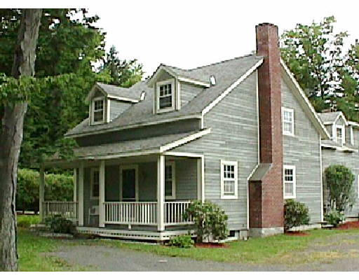 a view of a house with a yard and plants