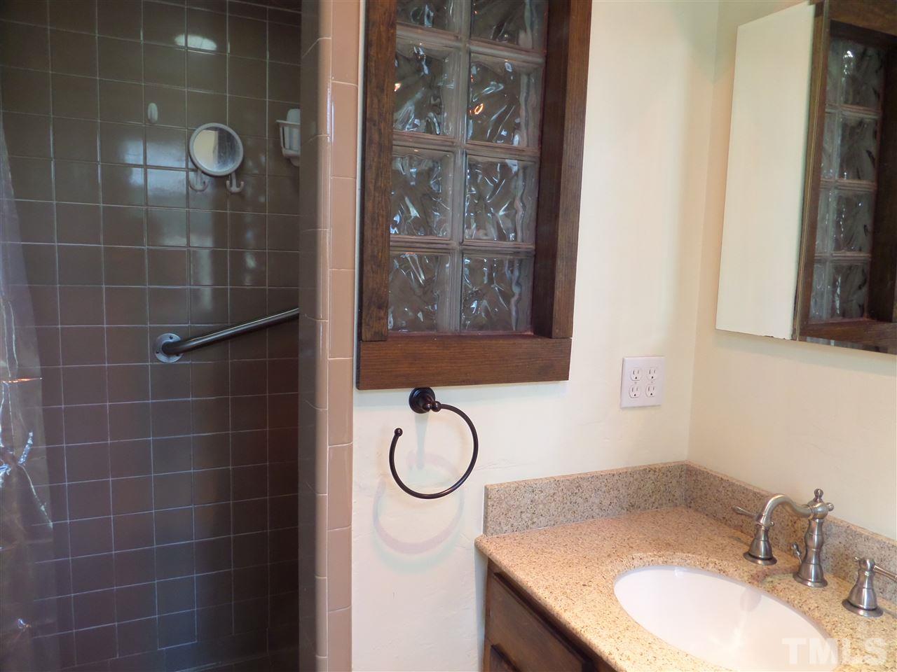 8725 Windjammer Drive Raleigh, NC 27615 - Photo 12 of 25 Ceramic bath and shower with new vanity and block for extra light