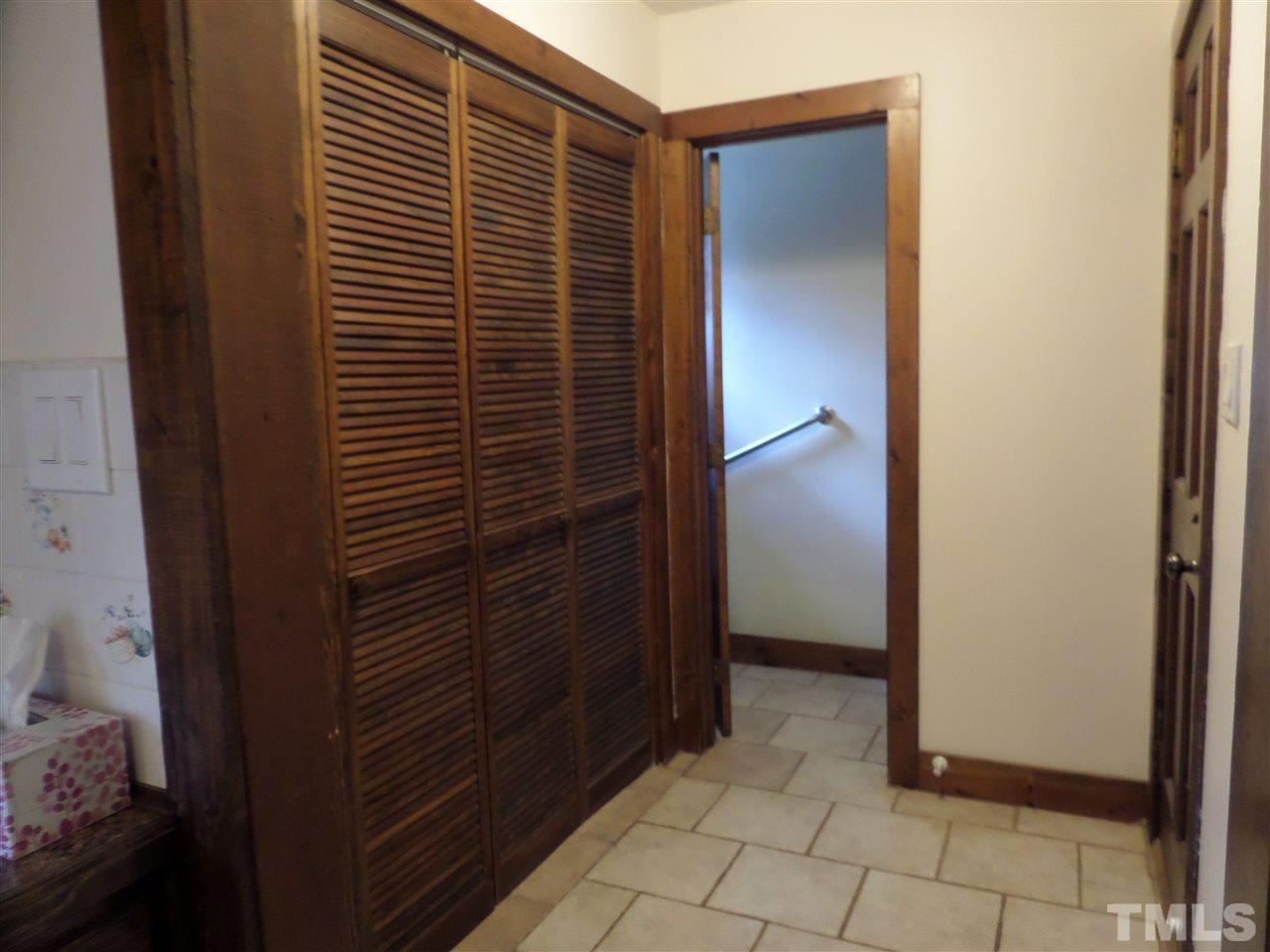 8725 Windjammer Drive Raleigh, NC 27615 - Photo 16 of 25 Good entrance from garage with tile floors- W/D and has half bath with tile