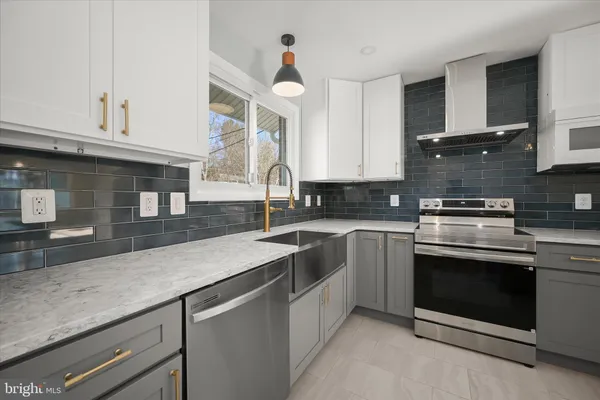 a kitchen with cabinets appliances a sink and a window