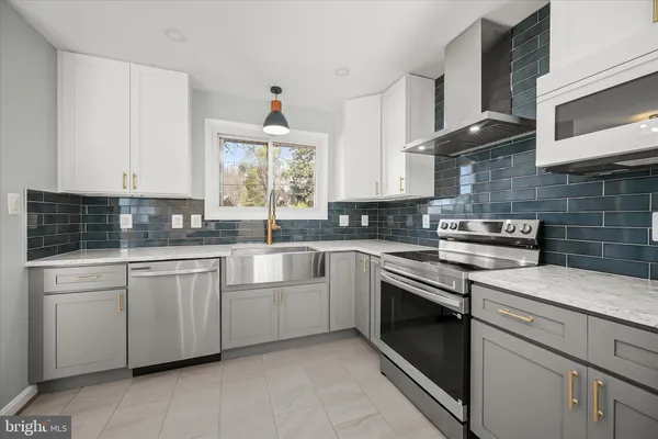a kitchen with stainless steel appliances granite countertop a sink stove and cabinets