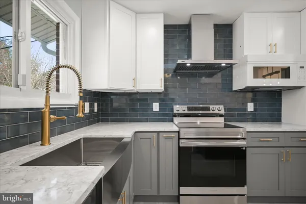 a view of a kitchen with a sink and a refrigerator