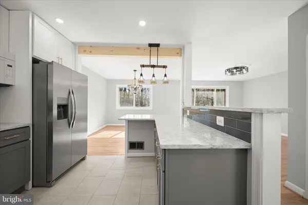 a view of a big room with wooden floor and a window
