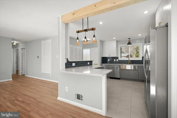 a view of a room with wooden floor and white walls