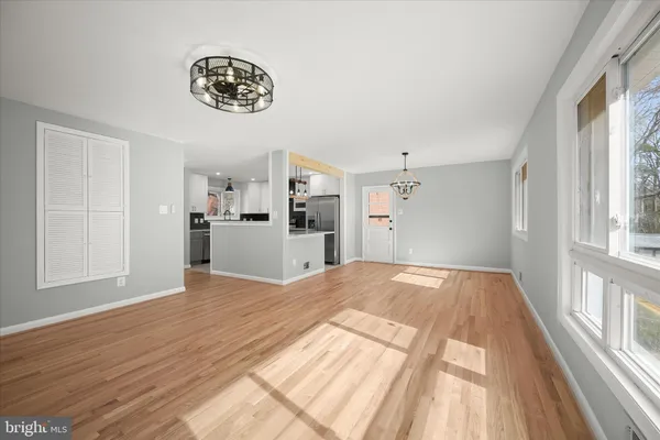 a view of a room with wooden floor and white walls