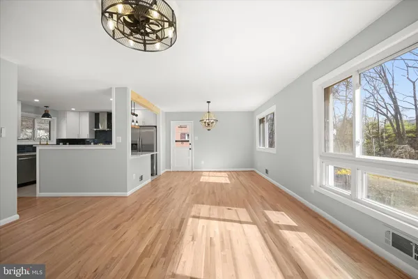 a view of a room with wooden floor and white walls