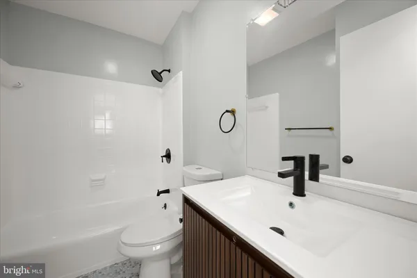 a view of a hallway with wooden floor and cabinet