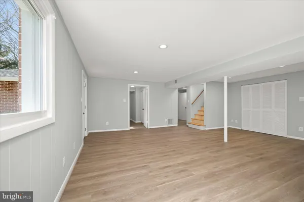 a view of a yard in front of a house with a large tree